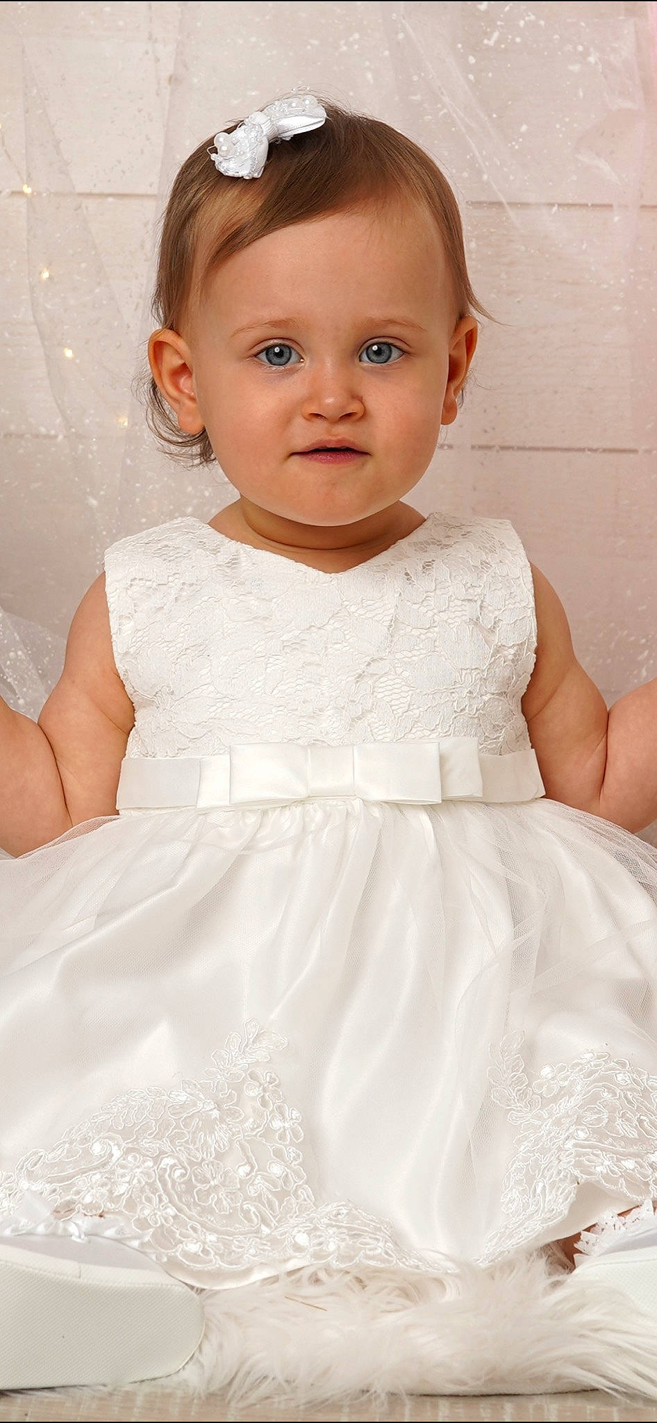 Lyna participe au concours pour gagner de l'argent avec cette photo : baby_toddler_clothing, bridal_accessory, day_dress, dress, eyelash, flash_photography, gown, hairstyle, happy, iris, lip, neck, one_piece_garment, person, pink, shoulder, skin, sleeve, standing, toddler