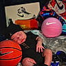 baby, sleeping, basketball, nike, jordan, black_clothing, hat, shoes, sneakers, sports, toy_basketball, boxes, pink_basketball, infant, resting, footwear, logo, indoor, soft_surface, cute