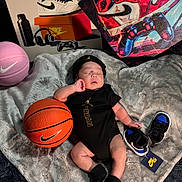 Bjorn Pineda is registered to the contest to win money with this photo: baby, infant, sleeping, basketball, sneakers, jordan, nike, black_clothing, blanket, hat, soft_texture, sports, toy_basketball, footwear, artwork, headwear, indoor, child, portrait, cute