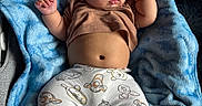 Bjorn Pineda is registered to the contest to win money with this photo: baby, sleeping, blanket, blue, brown_shirt, cartoon_pants, cozy, infant, cute, peaceful, resting, soft_texture, clothing, footwear, indoor, child, portrait, babywear, relaxation, naptime