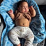 baby, sleeping, blanket, blue, brown_shirt, cartoon_pants, cozy, infant, cute, peaceful, resting, soft_texture, clothing, footwear, indoor, child, portrait, babywear, relaxation, naptime