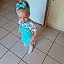 Louciana a rejoint le concours — aidez-le/la à gagner de superbes lots ! toddler, child, pacifier, headband, overalls, turquoise, tile_floor, indoor, shoes, white_shoes, cute, baby, person, standing, kitchen, cabinet, curious, young_child, clothing, floor
