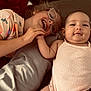 Mila-Rose joined the competition — help win amazing prizes! child, baby, smile, glasses, bed, pillow, hand_holding, shirt, onesie, happy, family, indoor, portrait, sibling, skin, cute, infant, toddler, love, relaxation