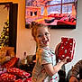 Mila-Rose is registered to the contest to win money with this photo: child, pajamas, glasses, gift, christmas, holiday, present, smile, indoor, living_room, tree, decorations, wrapped_presents, happy, person, celebration, festive, santa, holiday_spirit, family