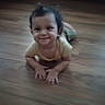Indigo is registered to the contest to win money with this photo: baby, child, crawling, floor, wooden_floor, smile, happy, indoors, young_child, person, hair, yellow_shirt, cute, face, hands, portrait, infant, toddler, playful, casual