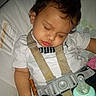 toddler, sleeping, car_seat, pretzel, baby_bottle, white_shirt, puma, seatbelt, child, curly_hair, indoors, peaceful, nap, infant, straps, safe, cute, young_child, resting, food