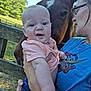 Ace is registered to the contest to win money with this photo: baby, child, adult, person, horse, animal, fence, outdoor, nature, trees, grass, glasses, shirt, holding, smiling, face, portrait, happy, daylight, casual
