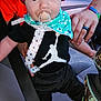 Ace joined the competition — help win amazing prizes! baby, pacifier, red_beanie, black_shirt, white_logo, car_seat, adult_hand, seatbelt, blue_bandana, infant, clothing, person, child, indoor, car_interior, holding, cute, portrait, closeup, support