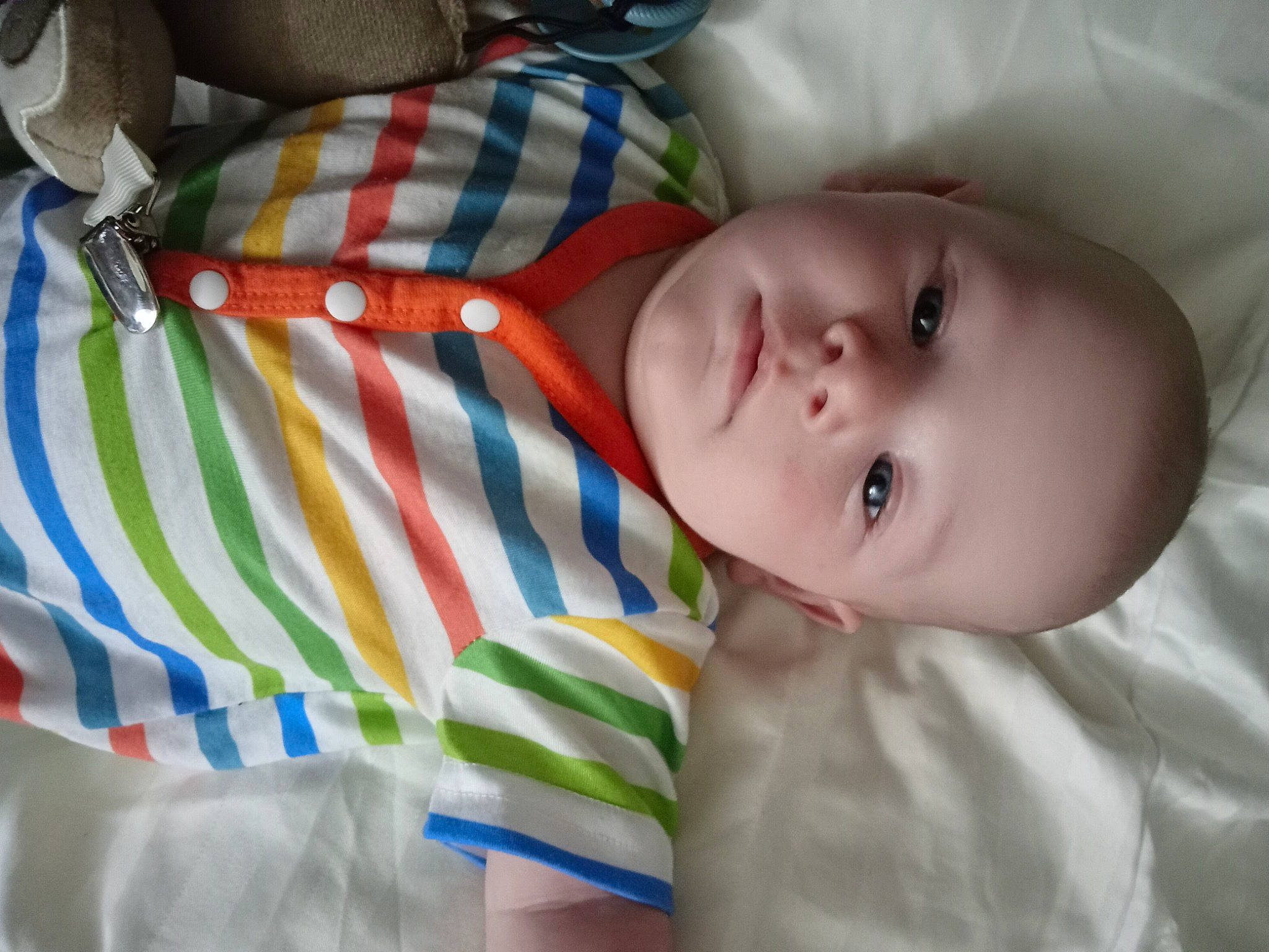 Leo is registered to the contest to win money with this photo: baby, baby_products, baby_toddler_clothing, cheek, child, comfort, elbow, eye, eyelash, flash_photography, hand, human_body, linens, nose, pattern, person, plaid, portrait_photography, room, sleeve