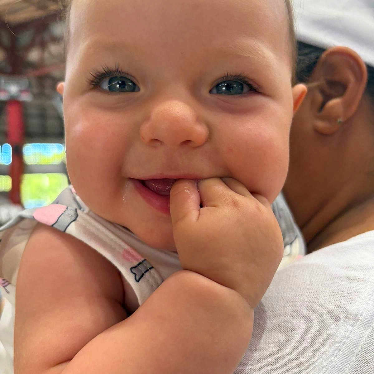 Amira joined the competition — help win amazing prizes! arm, baby, candid, caregiver, cheek, child, close_up, drool, ear, eyelashes, eyes, face, fingers, hand, indoor, infant, person, portrait, sleeveless_top, smile