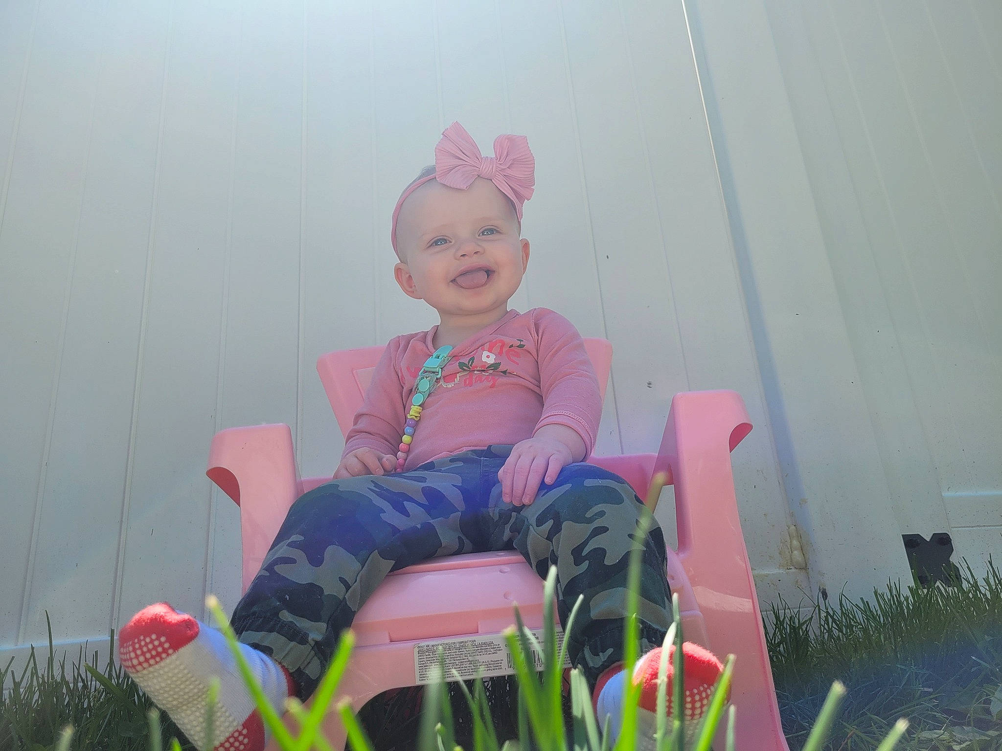 Fiona joined the competition — help win amazing prizes! baby, chair, child, eye, fun, grass, happy, hat, joy, leisure, magenta, people_in_nature, person, personal_protective_equipment, pink, plant, recreation, room, sitting, smile
