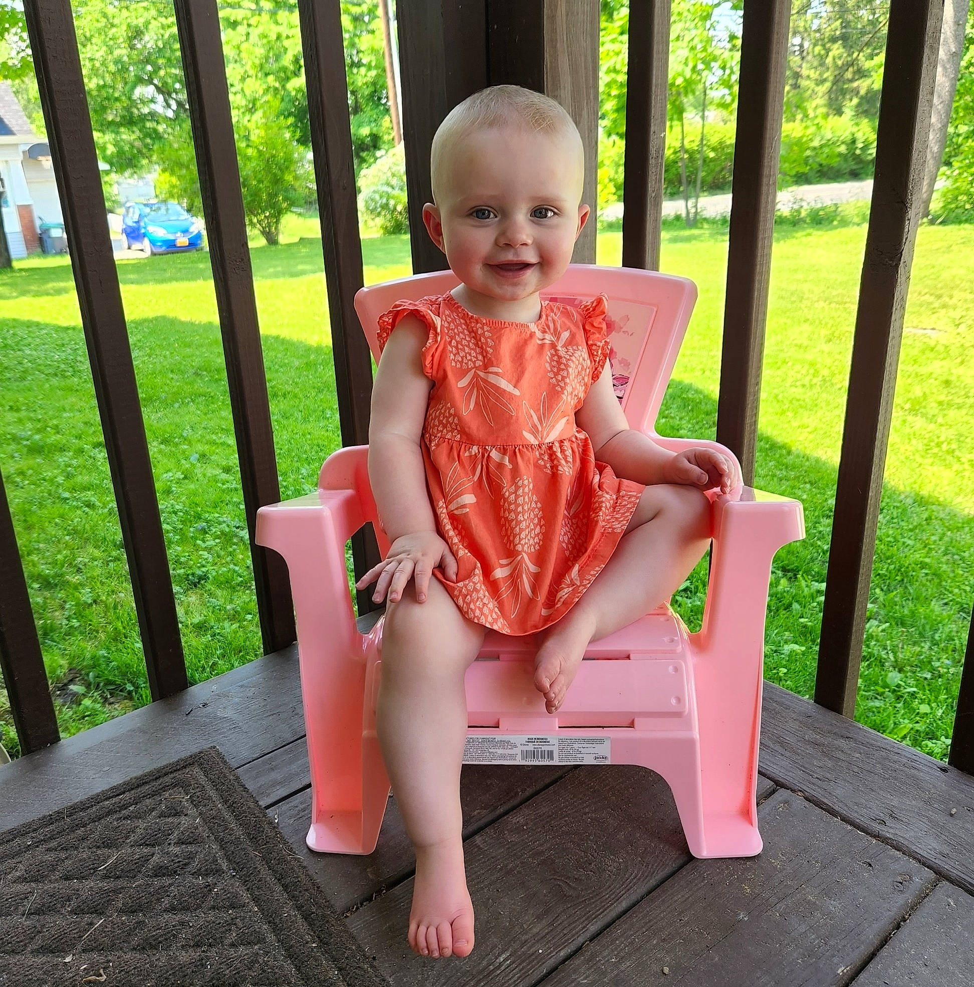Fiona is registered to the contest to win money with this photo: baby_toddler_clothing, beauty, dress, fun, grass, happy, joy, lap, leisure, magenta, outdoor_furniture, person, pink, plant, shorts, smile, summer, swing, thigh, toddler