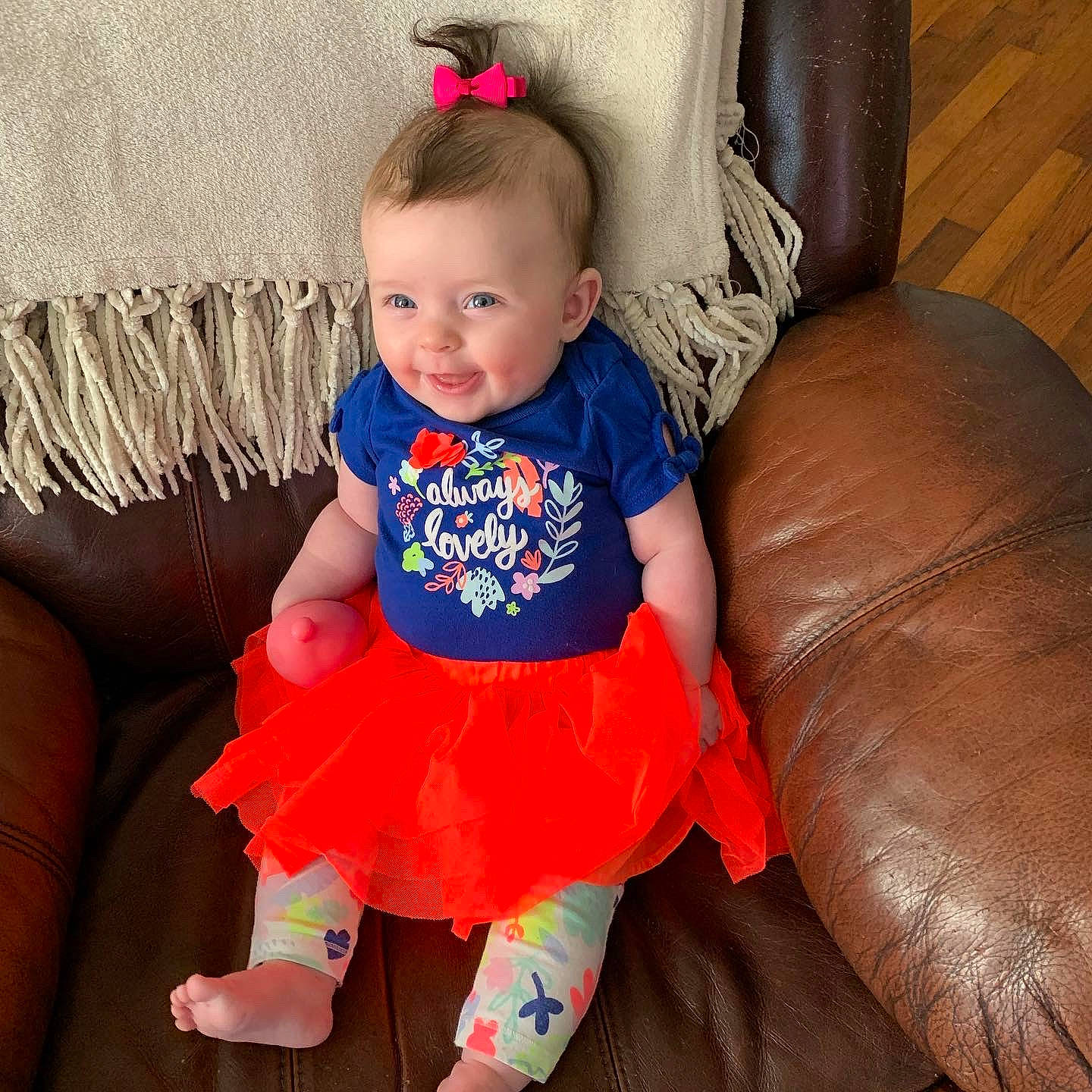 Kambri is registered to the contest to win money with this photo: baby, baby_toddler_clothing, child, comfort, couch, electric_blue, face, facial_expression, happy, iris, magenta, orange, person, pink, skin, sleeve, smile, standing, t_shirt, textile