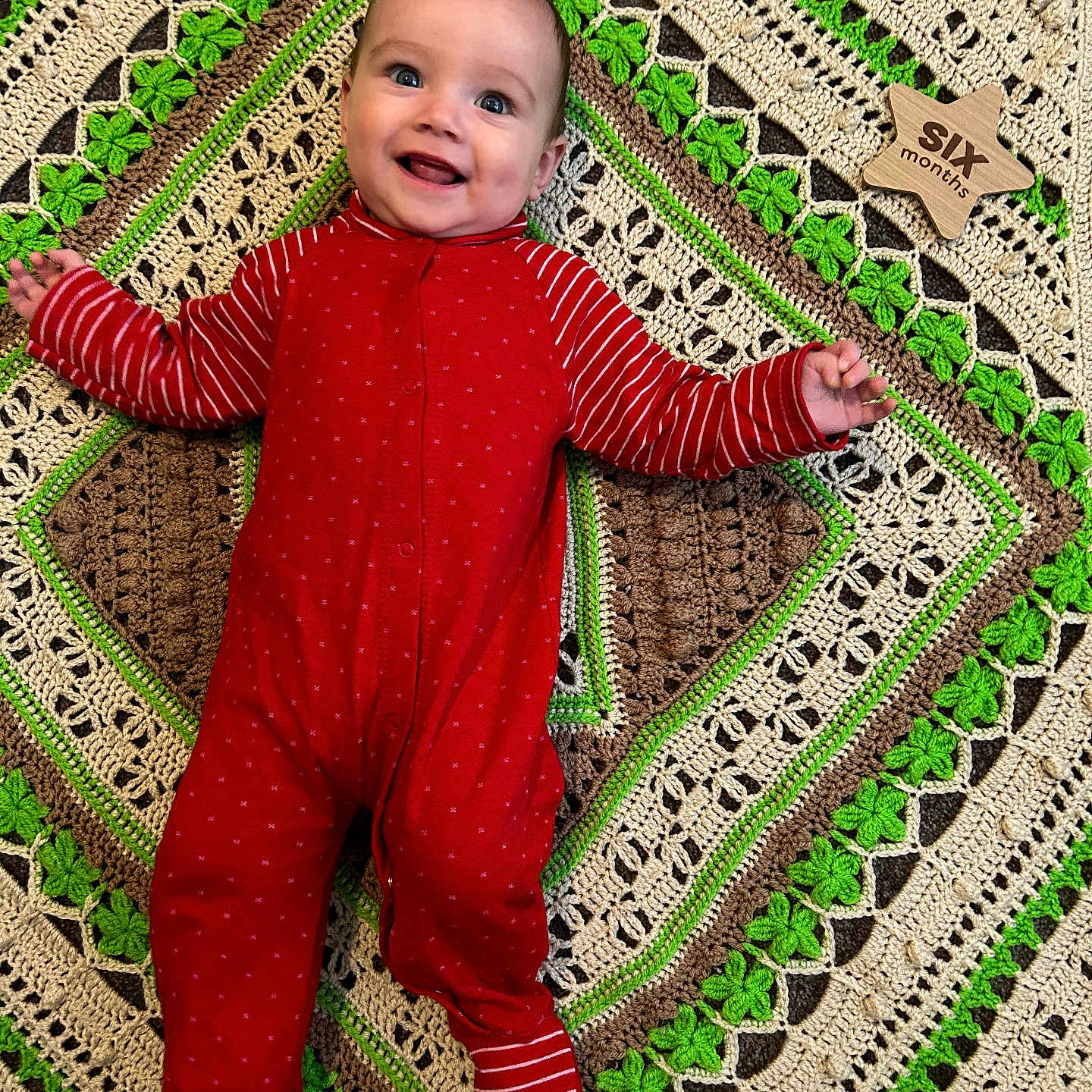 Mario is registered to the contest to win money with this photo: baby, blanket, clothing, cushion, face, furniture, happy, head, homedecor, hosiery, pajamas, pants, pattern, person, photography, portrait, quilt, smile, sock, standing