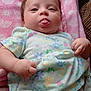 Skye joined the competition — help win amazing prizes! baby, infant, child, tongue_out, pink_blanket, floral_dress, diaper, cute, chubby_cheeks, lying_down, indoor, soft_texture, patterned_clothing, expression, human, small_hands, face, skin, adorable, playful