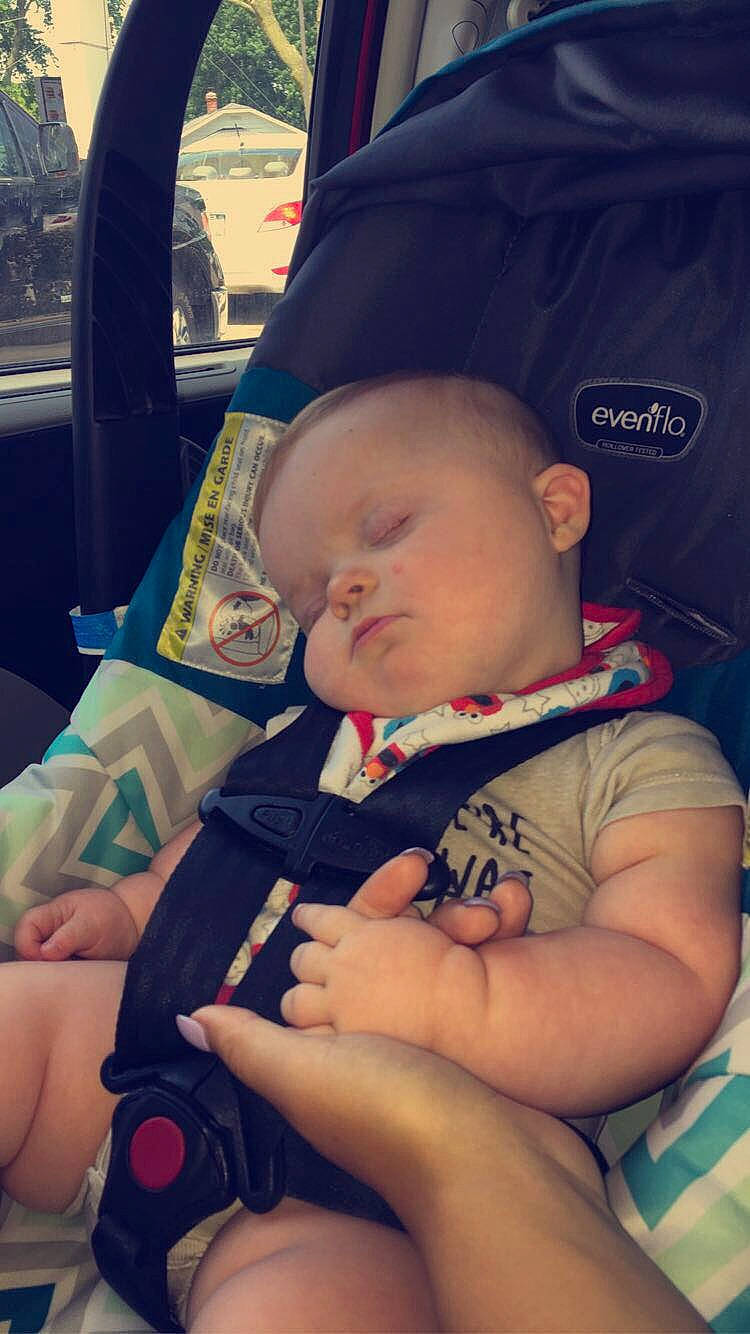 Emerson is registered to the contest to win money with this photo: baby, car_seat, cheek, child, cool, ear, eye, finger, fun, hand, head, leg, nap, nose, person, product, sitting, skin, sleep, toddler