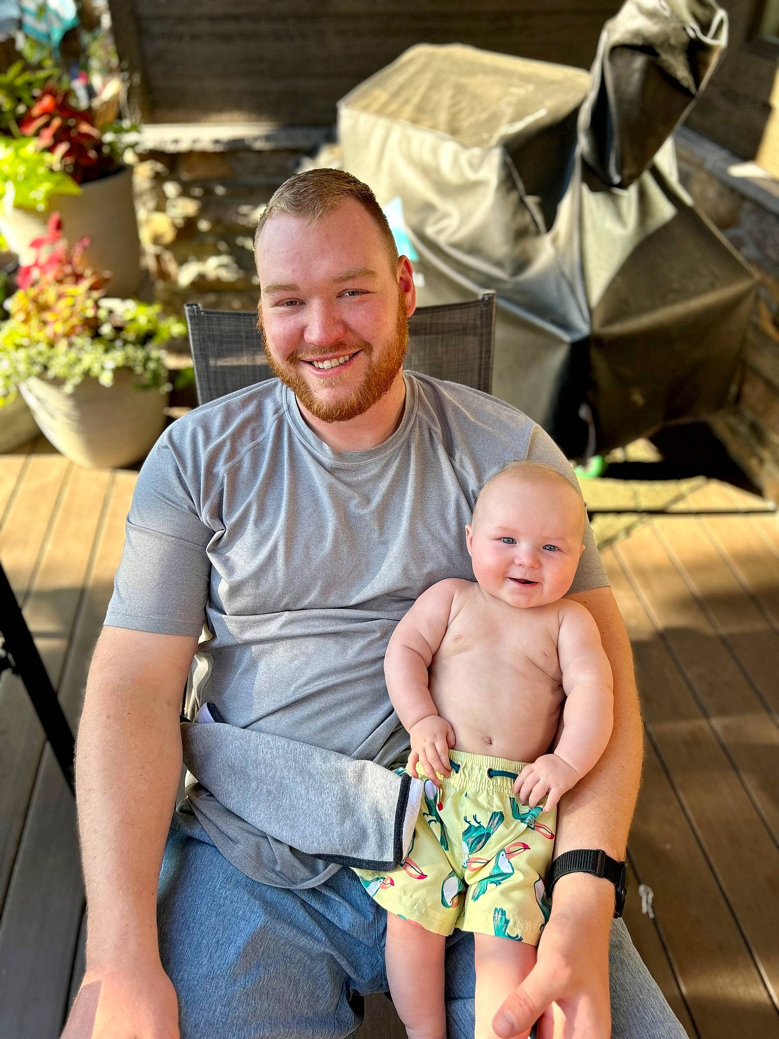 Maxwell Ethan is registered to the contest to win money with this photo: abdomen, baby, barefoot, event, flower, flowerpot, foot, fun, happy, houseplant, joy, lap, leisure, muscle, people, person, plant, shorts, sitting, smile