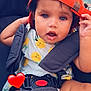 baby, child, cap, orange_cap, stroller, lemon_pattern, outdoor, cute, infant, seatbelt, red_heart_emoji, happy, summer, closeup, portrait, skin, small_hand, expression, casual, daylight