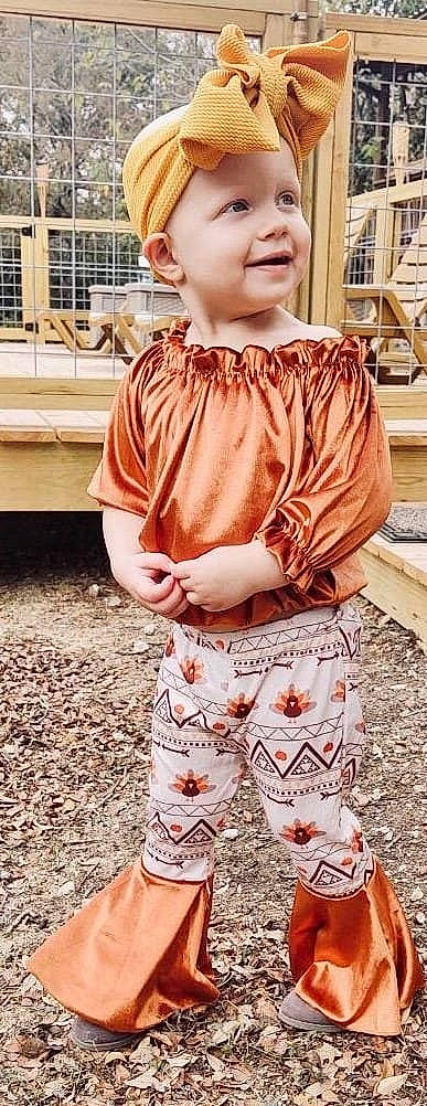 Braelyn is registered to the contest to win money with this photo: baby_toddler_clothing, child, cool, formal_wear, grass, hairstyle, happy, headwear, joy, neck, orange, outerwear, pattern, peach, person, shoulder, sleeve, standing, street_fashion, toddler