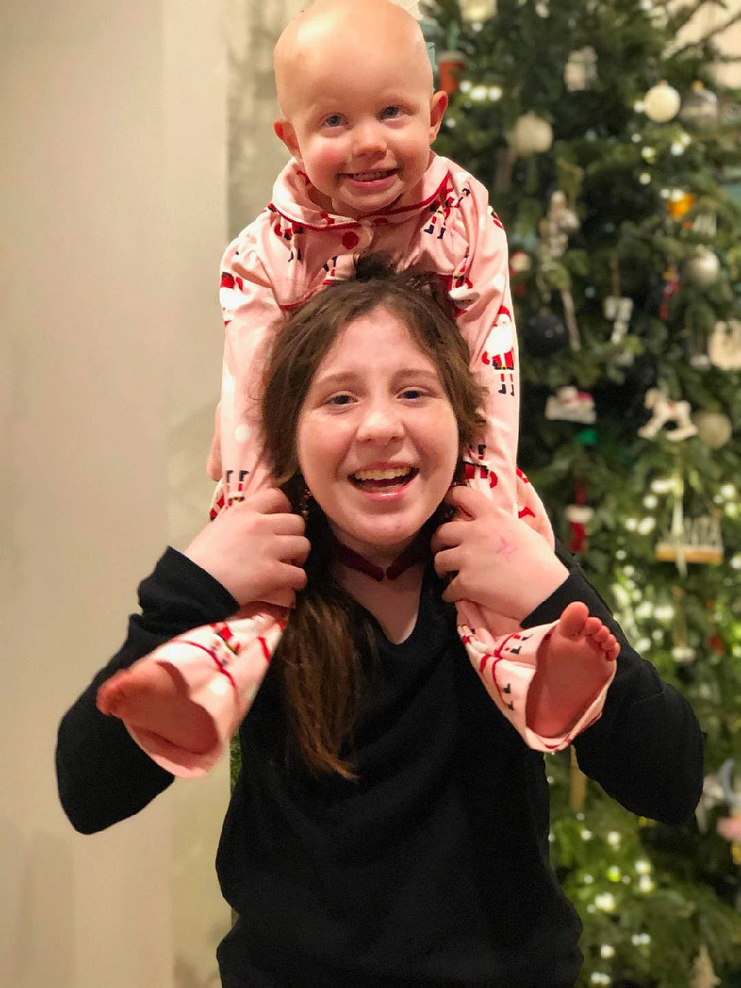 Bailee joined the competition — help win amazing prizes! arm, baby, christmas_tree, clothing, facial_expression, finger, flash_photography, fun, gesture, hand, happy, human, interaction, joy, outerwear, people_in_nature, person, pink, sleeve, smile