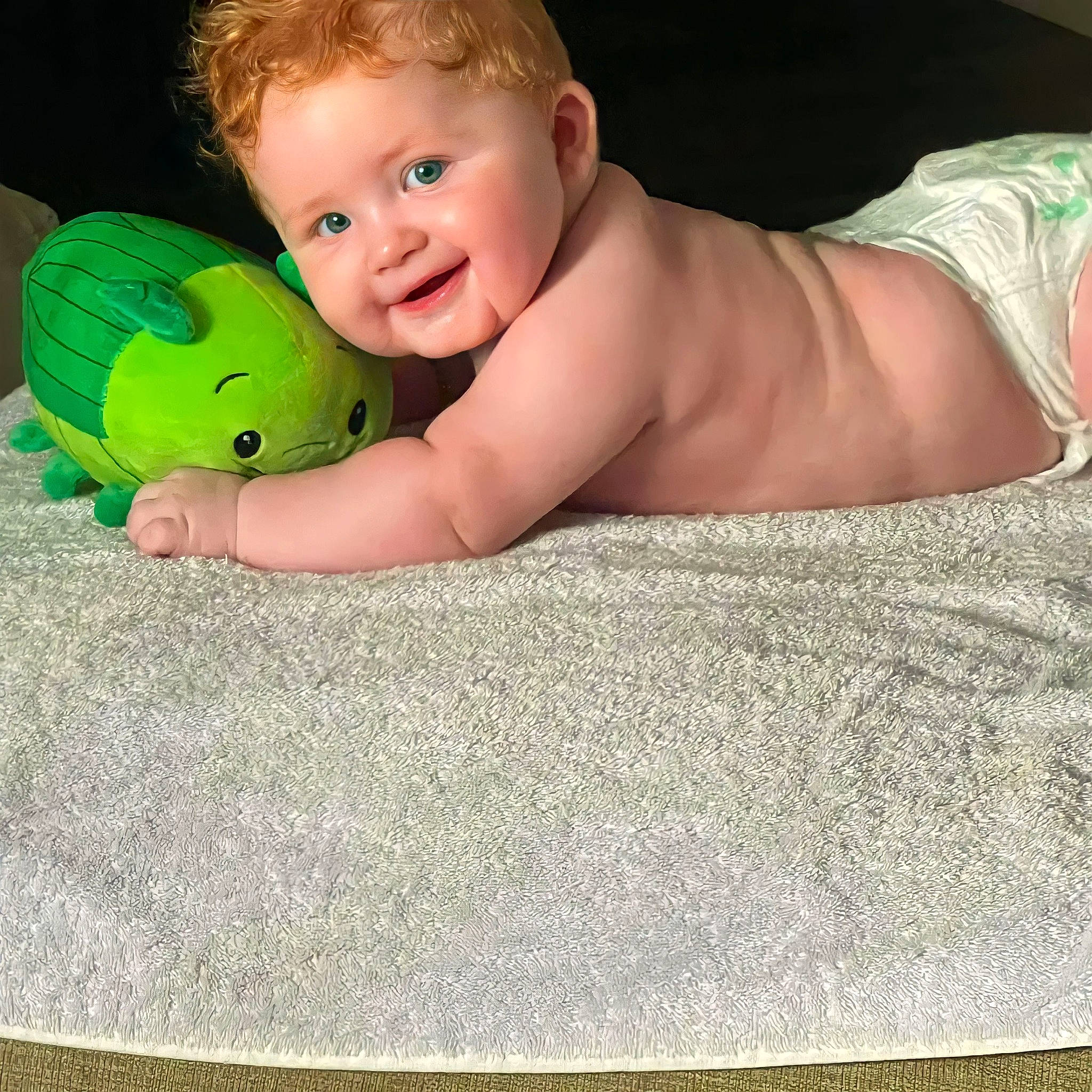 Ellie is registered to the contest to win money with this photo: baby, baby_playing_with_toys, baby_toddler_clothing, chest, child, comfort, eye, finger, foot, fun, grass, happy, head, human_body, linens, person, skin, smile, thumb, toddler