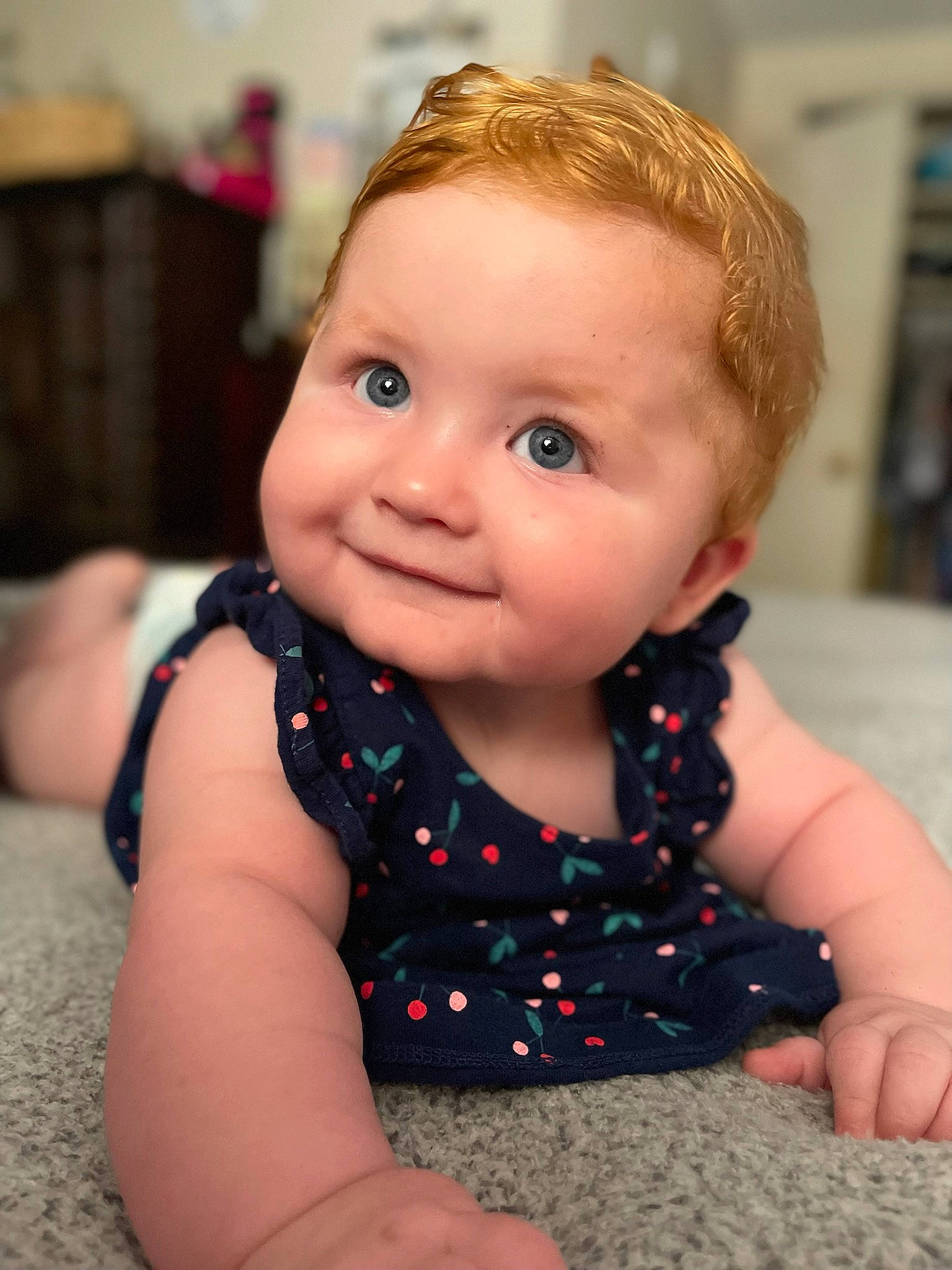Ellie is registered to the contest to win money with this photo: arm, baby_toddler_clothing, cheek, child, chin, eye, finger, floor, flooring, hairstyle, happy, head, iris, joy, mouth, nose, person, skin, sleeve, smile