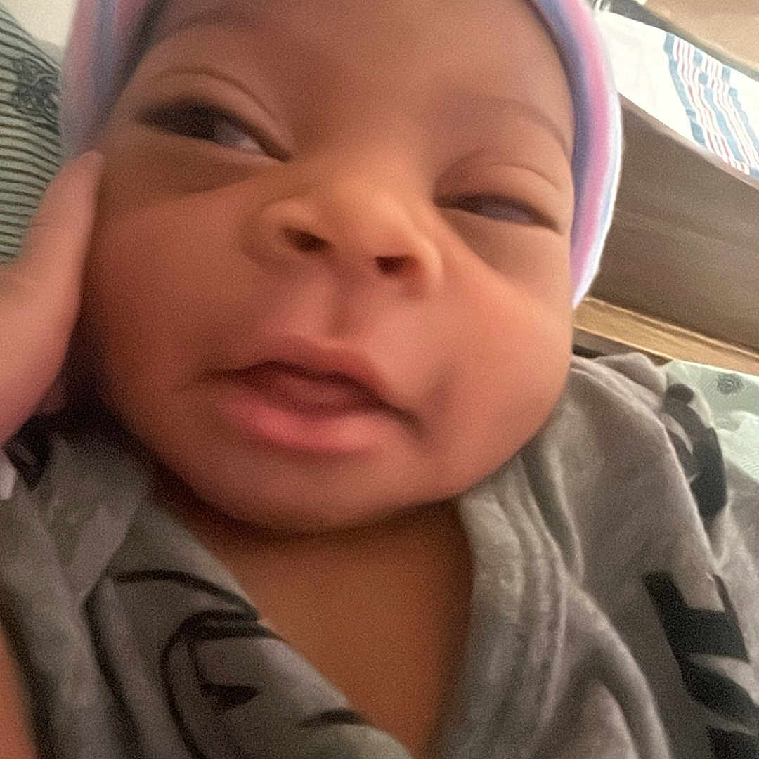 Kingston joined the competition — help win amazing prizes! baby, newborn, hat, blanket, face, person, infant, clothing, closeup, indoors, sleepwear, headwear, skin, cute, child, portrait, young, resting, cozy, expression