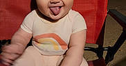 Addilynn joined the competition — help win amazing prizes! baby, child, smiling, tongue_out, red_chair, sitting, cute, happy, infant, playful, outdoor, night, clothing, person, portrait, baby_clothes, skin, head, face, expression