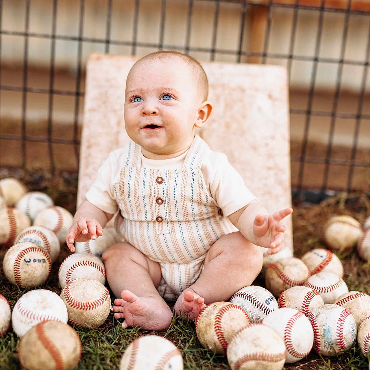 Eastyn is registered to the contest to win money with this photo: baby, barefoot, baseball, blue_eyes, child, clothing, cute, fence, fun, grass, happy, infant, nature, outdoor, playful, portrait, sitting, sports, summer, toy