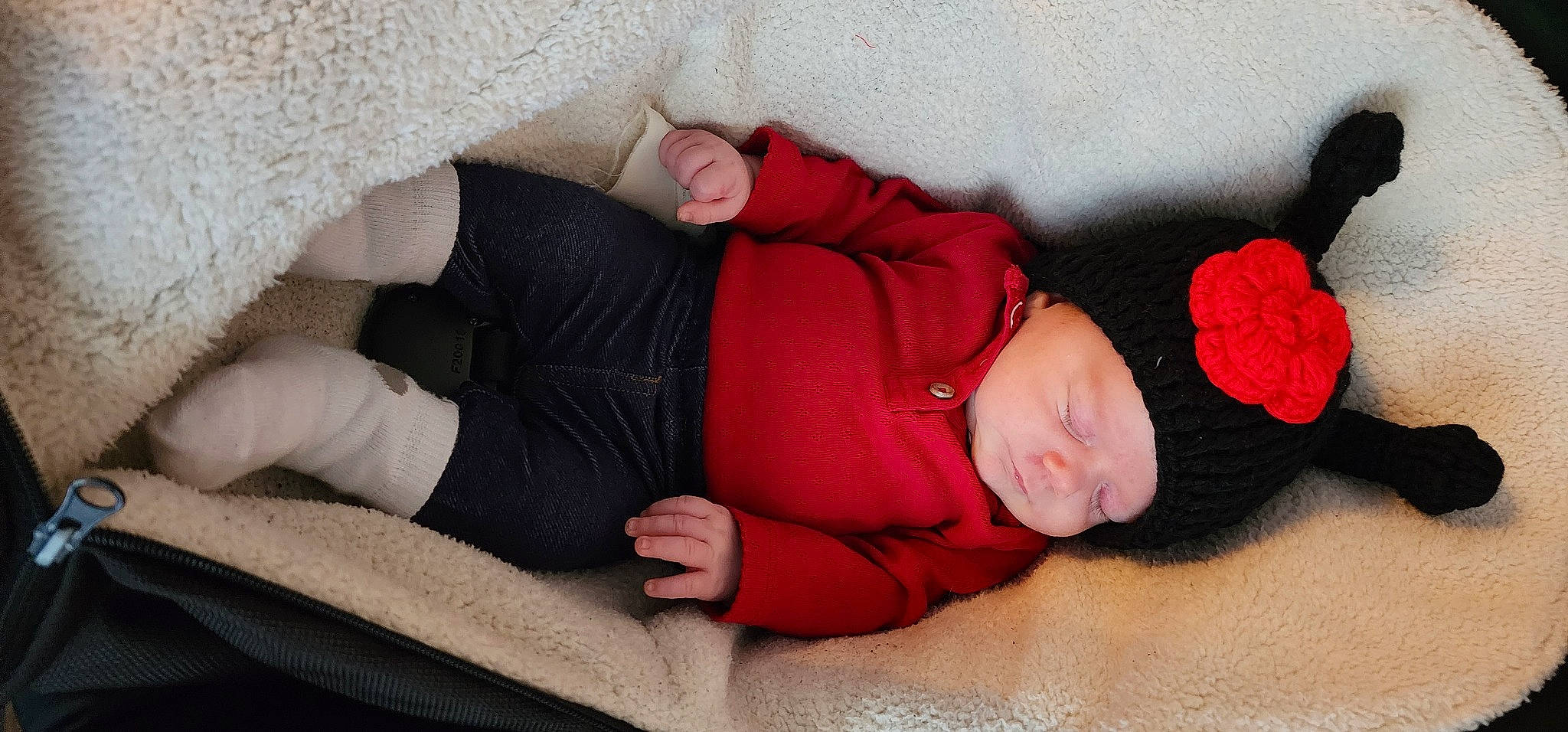 Baileigh joined the competition — help win amazing prizes! baby, baby_sleeping, baby_toddler_clothing, bedding, bedtime, carmine, child, comfort, couch, headwear, human_leg, knee, linens, mammal, nap, person, red, room, sitting, sleeve