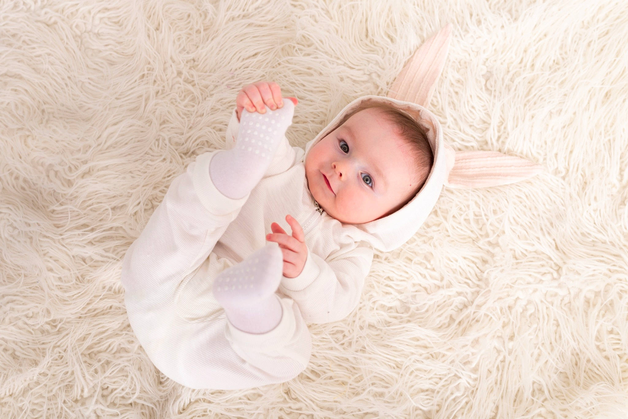 Colson is registered to the contest to win money with this photo: baby, baby_toddler_clothing, cheek, child, comfort, eye, face, flooring, fur, grass, happy, head, human_body, linens, pattern, person, skin, sleeve, textile, toddler