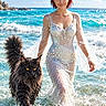 beach, black_cat, cat, coastline, dress, fantasy, gown, jewelry, ocean, outdoor, pearls, portrait, red_hair, seawater, sparkles, sunlight, surf, waves, wet, woman