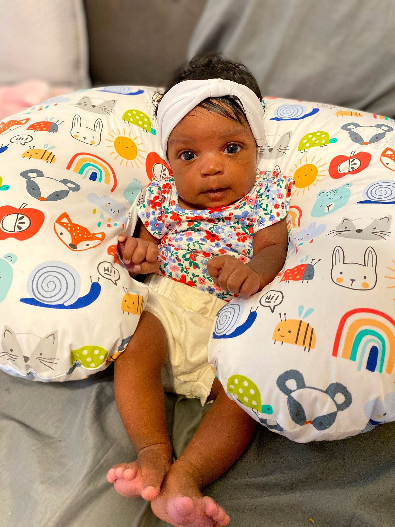 Hazel is registered to the contest to win money with this photo: baby, baby_toddler_clothing, cheek, child, comfort, couch, facial_expression, fun, happy, head, headwear, human_leg, linens, mammal, person, product, skin, t_shirt, textile, thigh