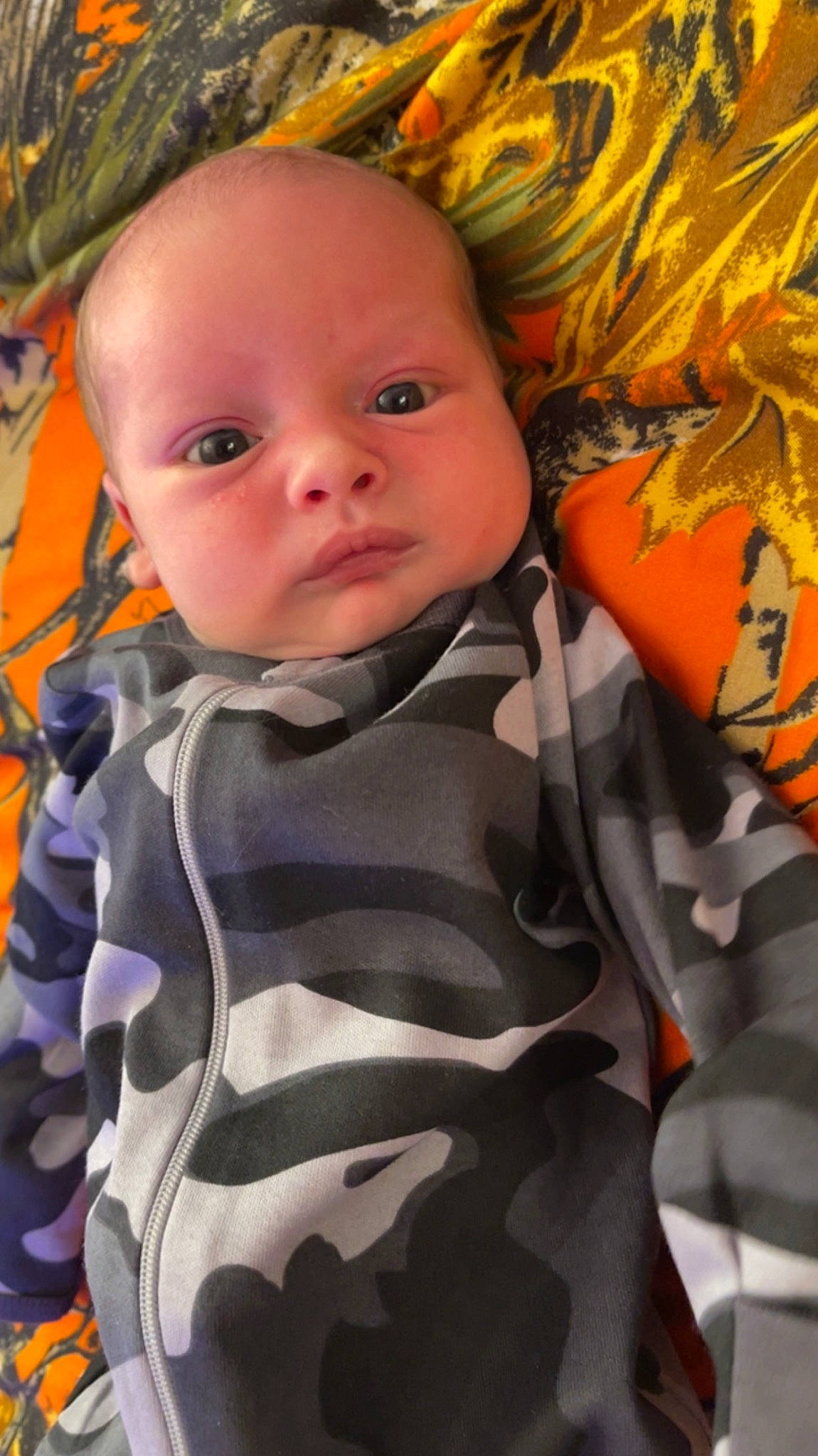 Billy is registered to the contest to win money with this photo: baby, baby_products, baby_toddler_clothing, cheek, child, comfort, eye, face, grass, happy, head, iris, linens, pattern, person, plant, skin, sleeve, t_shirt, textile