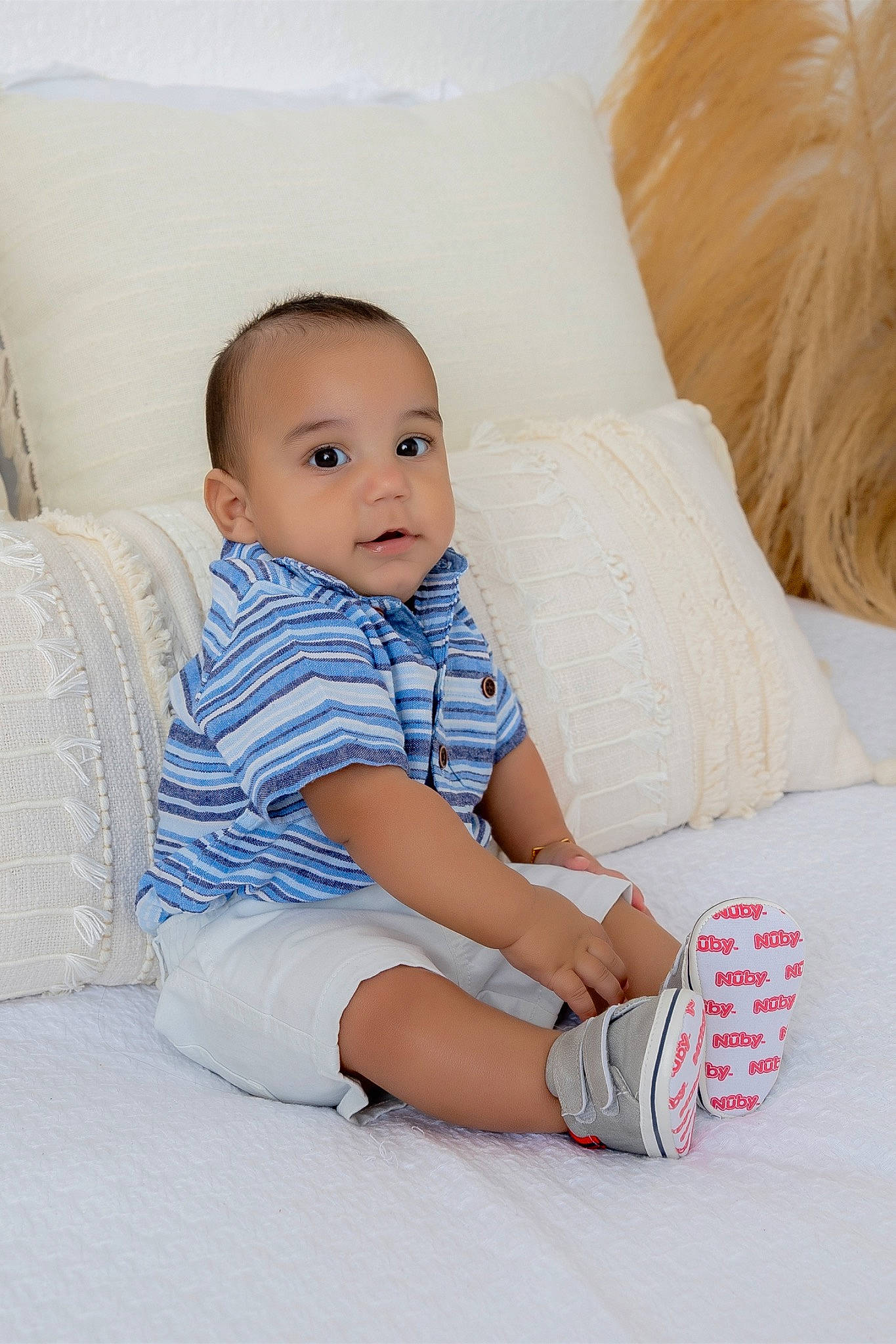 Anthony joined the competition — help win amazing prizes! baby, baby_toddler_clothing, child, comfort, couch, electric_blue, flooring, hairstyle, happy, human_leg, knee, linens, pattern, person, sitting, skin, sleeve, sock, textile, thigh