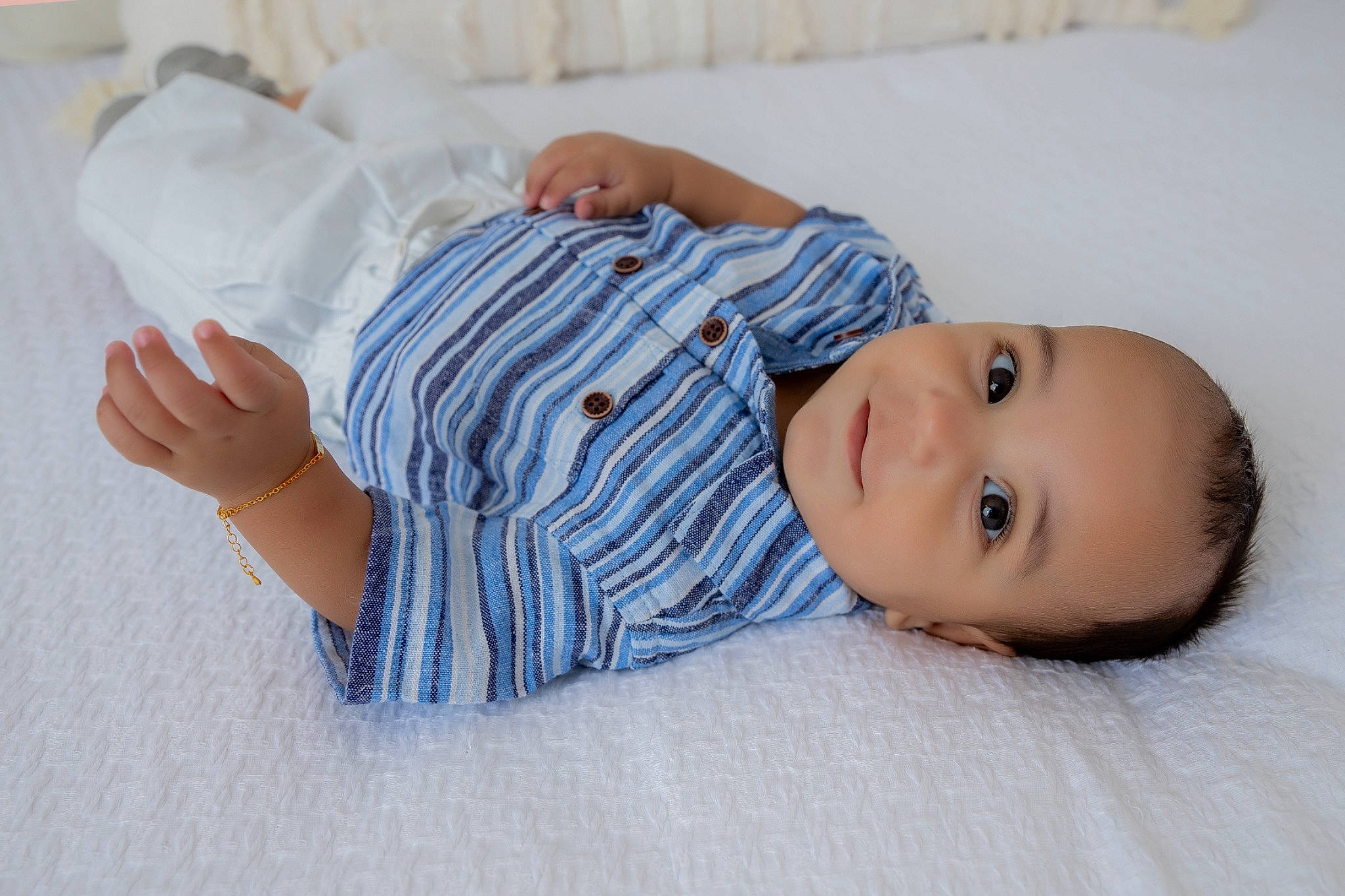 Anthony is registered to the contest to win money with this photo: baby, baby_toddler_clothing, bedtime, child, collar, comfort, linens, pattern, person, portrait_photography, room, sitting, skin, sleeve, smile, toddler