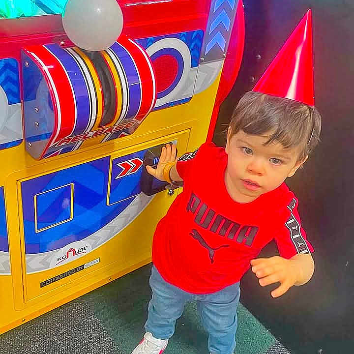 Jose Robles Carrillo joined the competition — help win amazing prizes! child, toddler, boy, arcade, arcade_machine, game, indoors, portrait, standing, smiling, red_shirt, puma_shirt, jeans, sneakers, playground, entertainment, colorful, game_room, floor, face