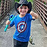 Luke is registered to the contest to win money with this photo: child, boy, fishing_rod, fish, cowboy_hat, bridge, outdoor, nature, trees, greenery, concrete_path, smiling, blue_shirt, jeans, sneakers, recreation, summer, catch, happy, adventure