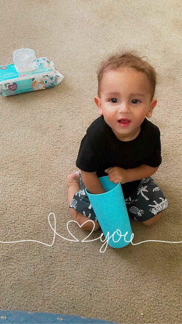 Lucas is registered to the contest to win money with this photo: baby, baby_playing_with_toys, baby_toddler_clothing, child, electric_blue, flooring, fun, grass, happy, leisure, pattern, person, play, product, sitting, sleeve, smile, sock, t_shirt, toddler