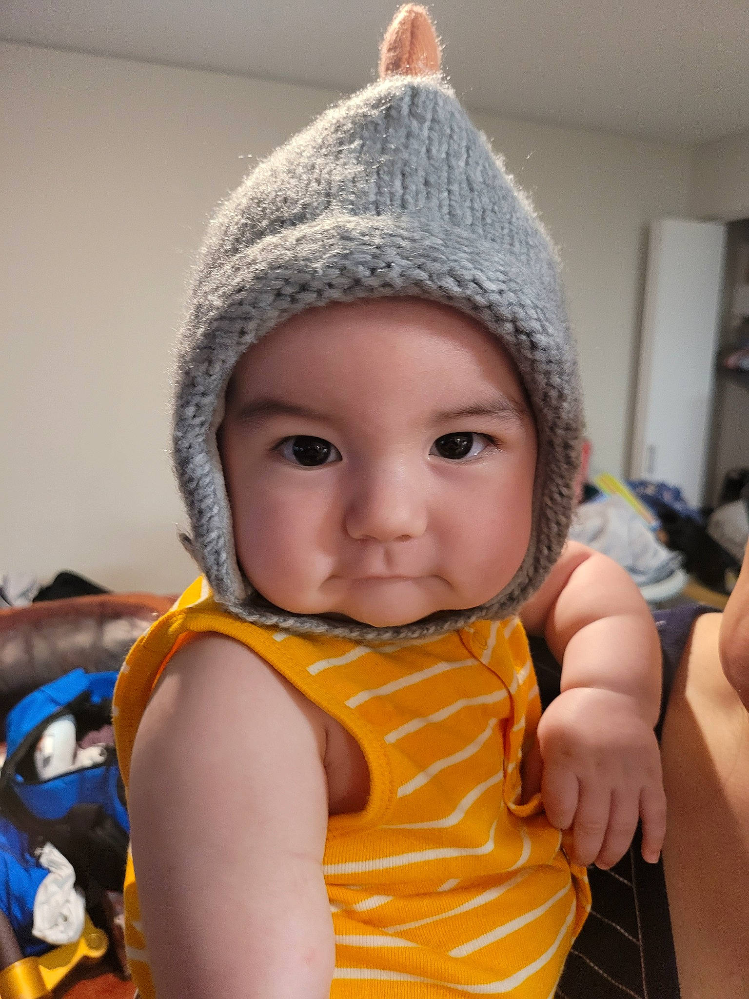 Riku is registered to the contest to win money with this photo: baby, baby_toddler_clothing, beanie, cap, cheek, child, eye, fashion_accessory, fun, happy, head, headwear, knit_cap, nose, pattern, person, skin, sleeve, thumb, toddler