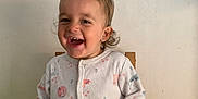 Maddy participe au concours pour gagner de l'argent avec cette photo : toddler, child, smiling, onesie, animal_print, chair, indoor, happy, cute, person, sitting, clothing, baby, eating, skin, head, hair, earrings, face, expression