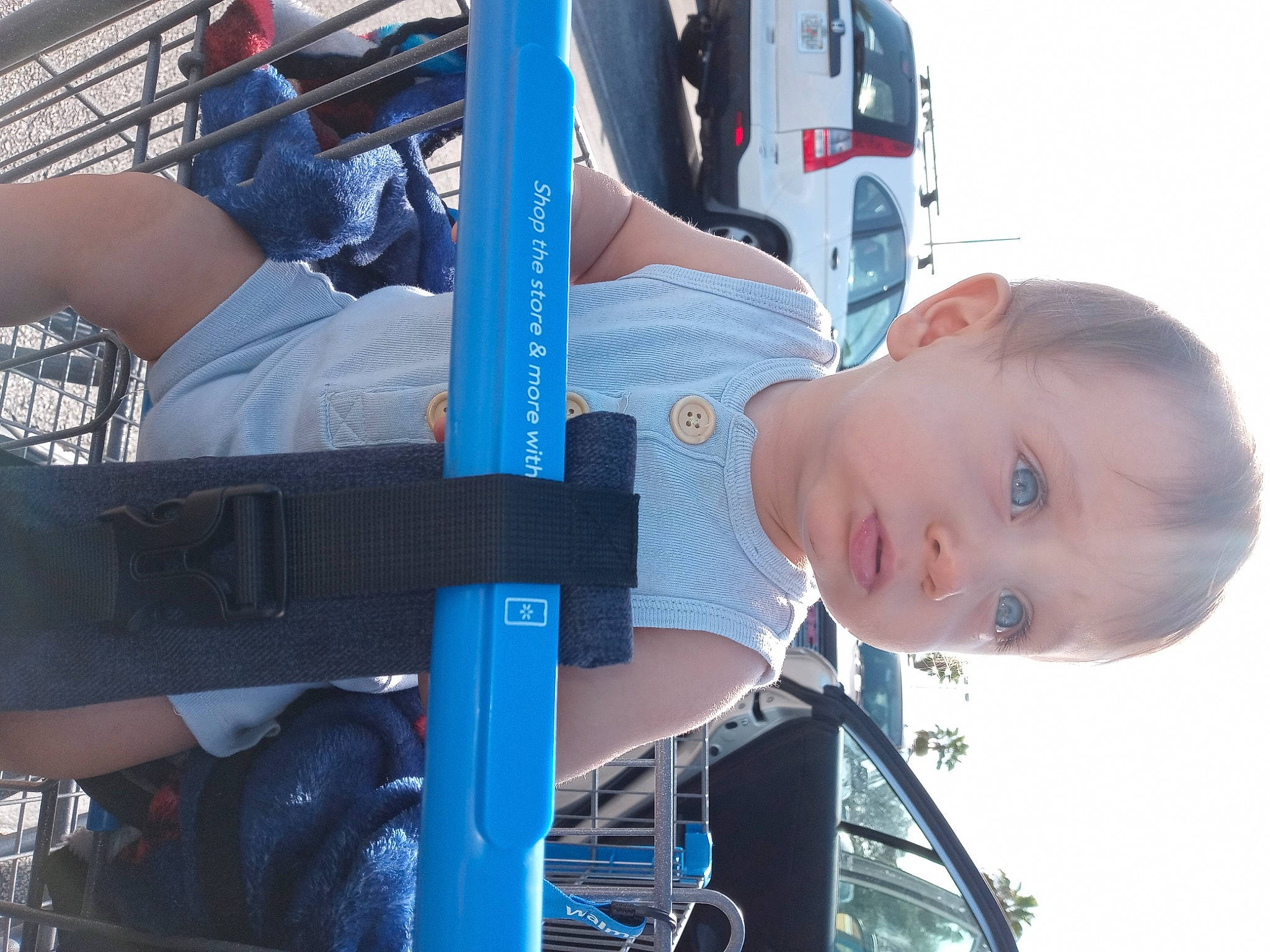 Billy is registered to the contest to win money with this photo: auto_part, automotive_design, automotive_exterior, automotive_tire, automotive_wheel_system, baby, baby_toddler_clothing, blue, bumper, electric_blue, engineering, fun, hat, machine, motor_vehicle, person, sky, sorrow, t_shirt, toddler