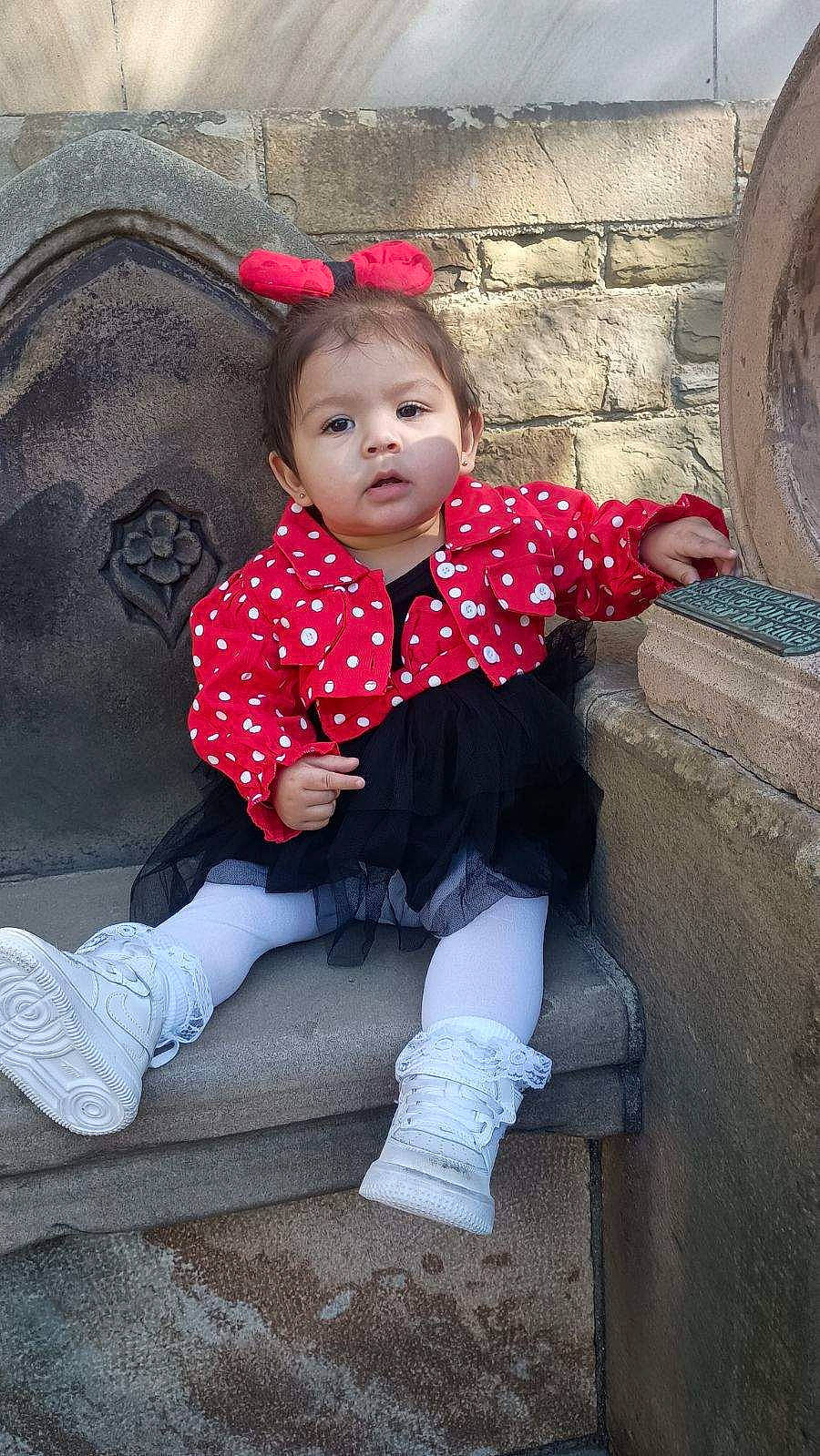 Joselyn is registered to the contest to win money with this photo: baby_toddler_clothing, cheek, cool, eye, flash_photography, grass, happy, head, leg, lip, magenta, pattern, person, pink, sitting, sleeve, standing, textile, thigh, tints_and_shades