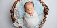 Raylan is registered to the contest to win money with this photo: baby, basket, blanket, blue, cozy, cushion, cute, hands, head, infant, newborn, peaceful, portrait, resting, sleeping, soft, swaddle, texture, white, wrapped