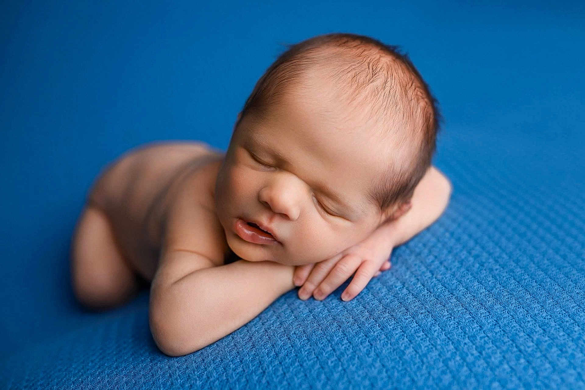 Raylan joined the competition — help win amazing prizes! newborn, baby, sleeping, blue_blanket, closeup, infant, peaceful, skin, face, head, hands, resting, soft_light, portrait, young_child, cute, small, lying_down, texture, indoors