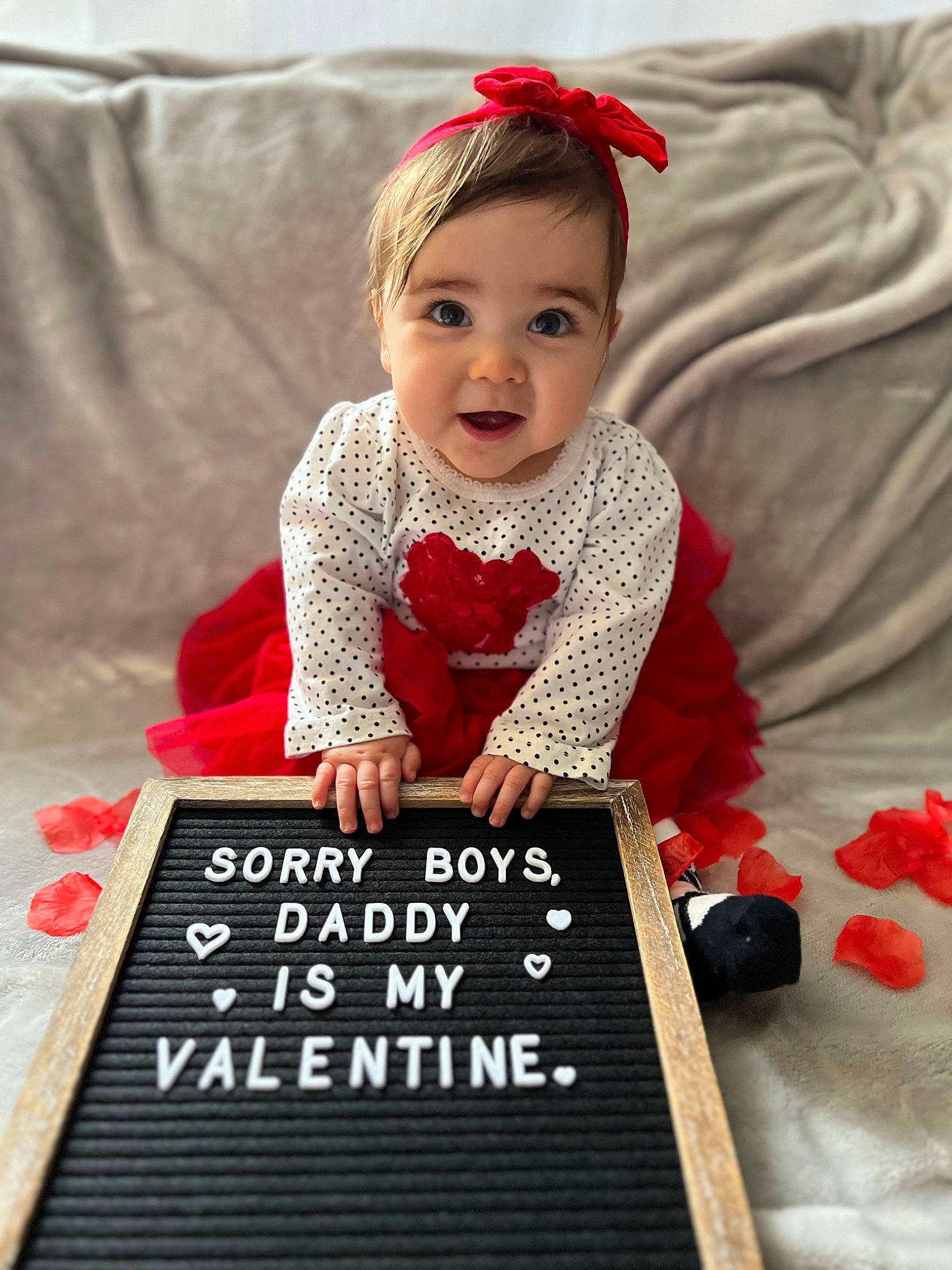 Isabell joined the competition — help win amazing prizes! arm, baby, baby_toddler_clothing, beauty, child, couch, dress, face, flooring, font, happy, pattern, person, red, room, sitting, sleeve, smile, table, toddler