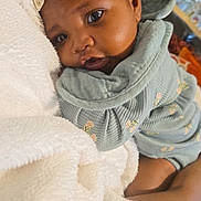 Kalynn King joined the competition — help win amazing prizes! baby, child, face, headband, bow, blanket, clothing, floral_pattern, couch, indoor, person, portrait, cute, snuggling, soft_texture, infant, warm, happy, skin, closeup
