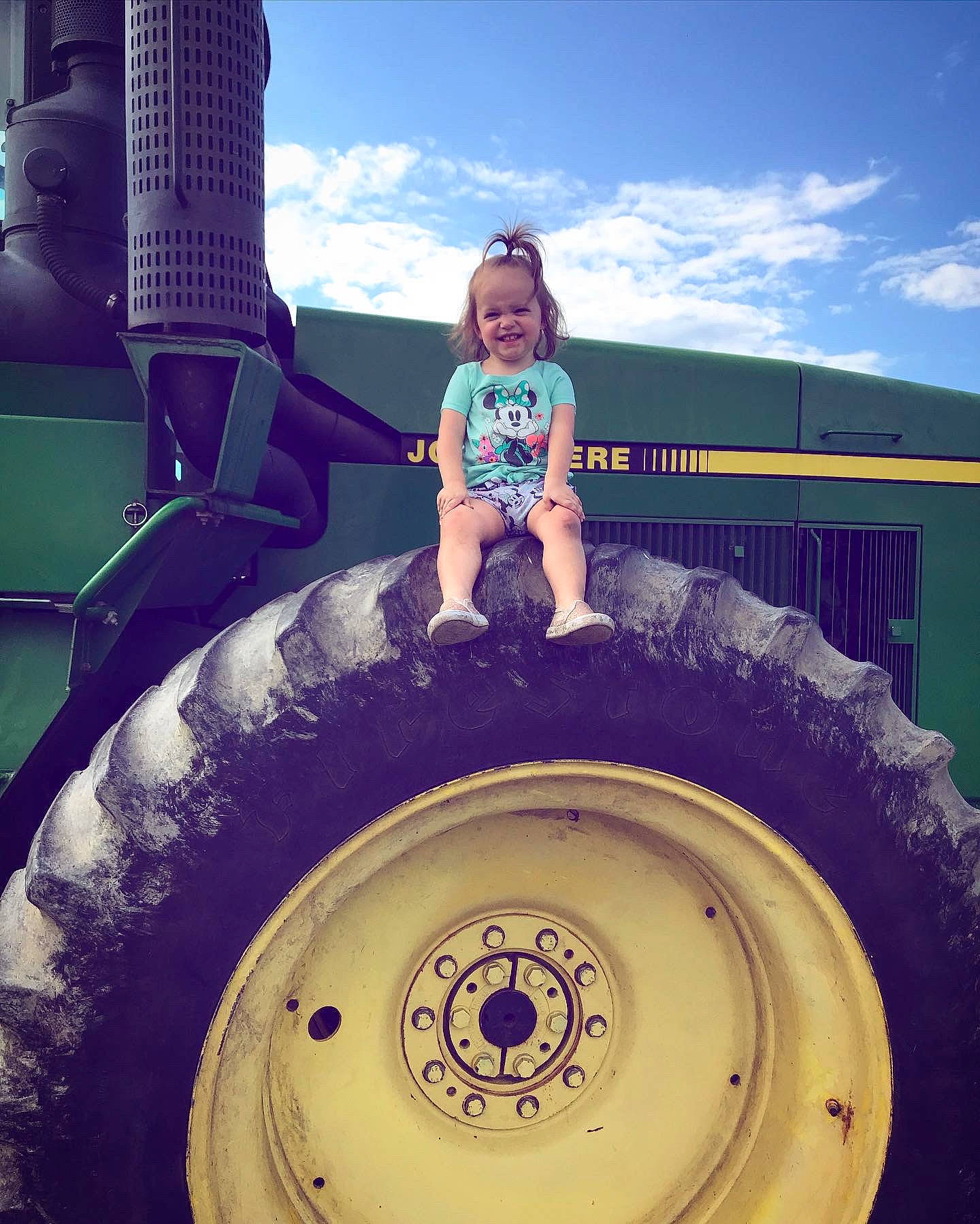 Chelsea is registered to the contest to win money with this photo: auto_part, automotive_tire, automotive_wheel_system, child, cloud, cool, eye, fun, joy, person, play, sky, smile, tire, toddler, vacation, vehicle, wheel