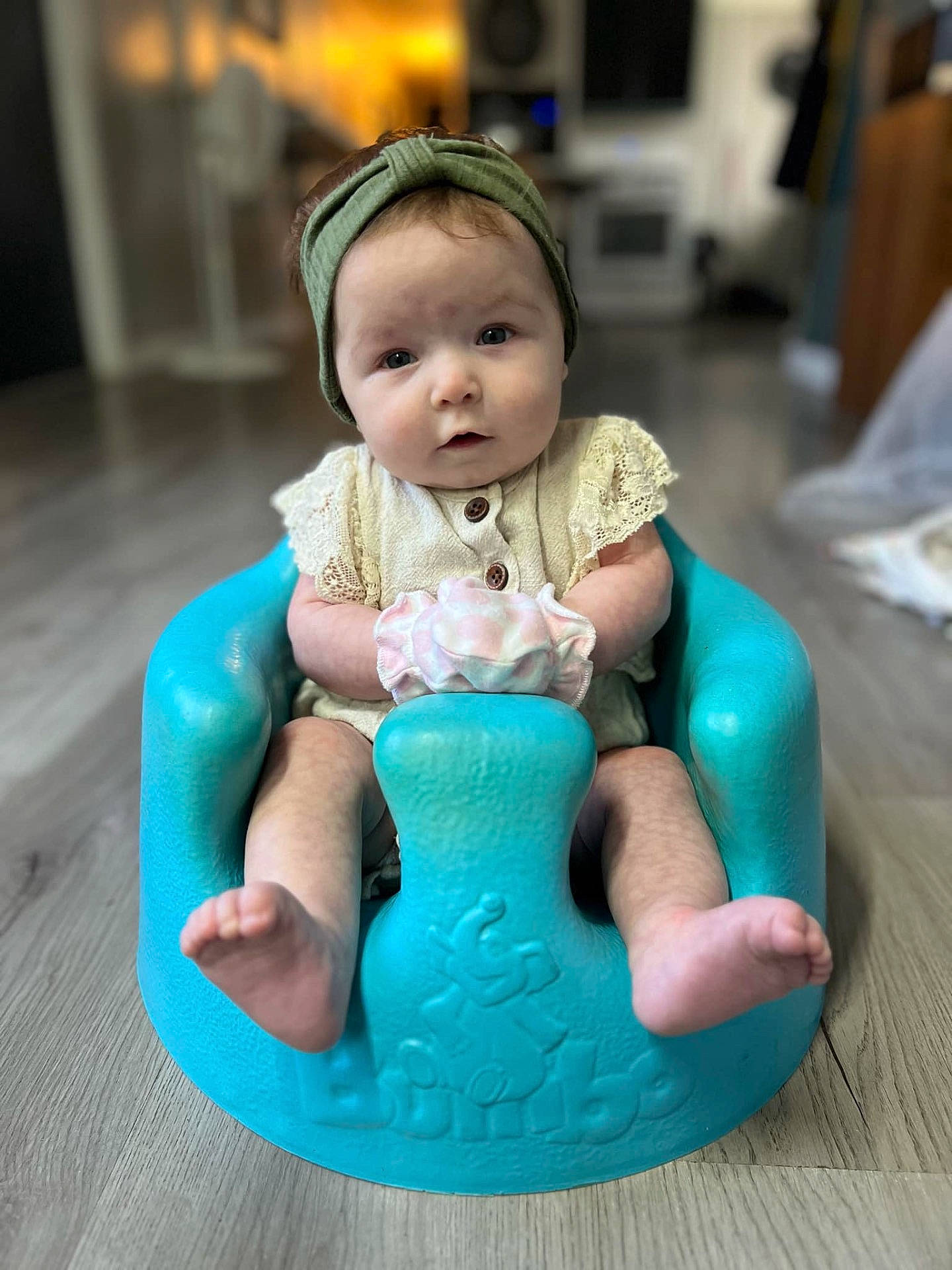 animal, baby, bathroom, clothing, face, furniture, happy, hat, head, indoors, newborn, person, pet, photography, playarea, portrait, room, sitting, smile, toy