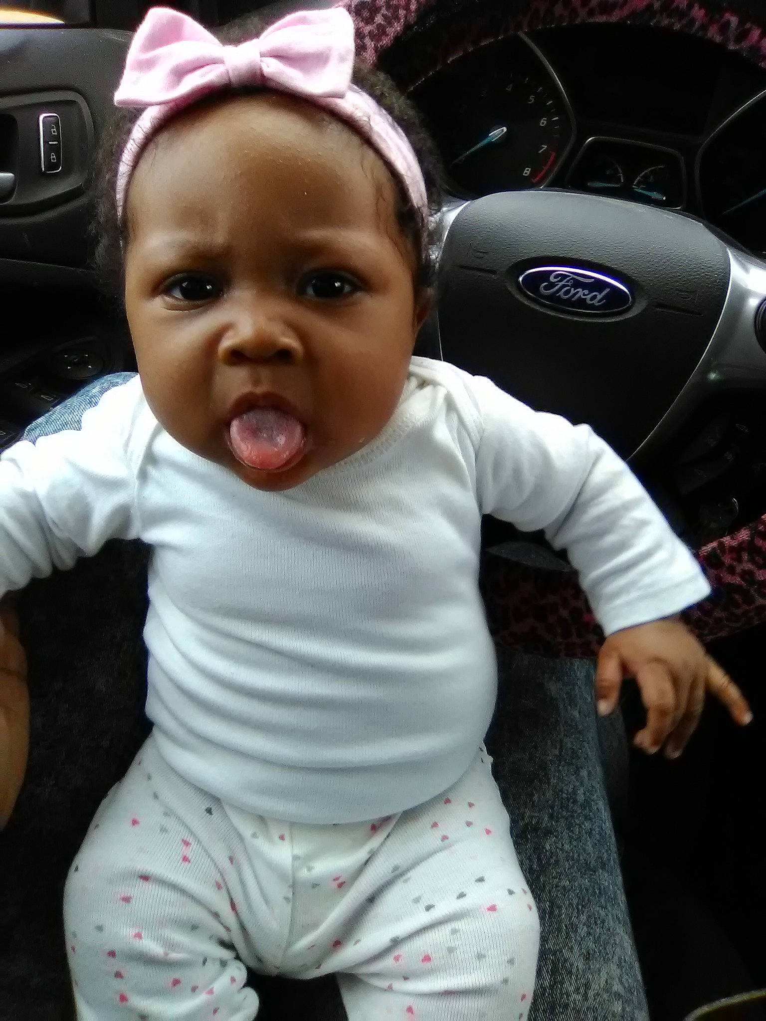 Lizzie is registered to the contest to win money with this photo: baby, car, cheek, child, cool, head, headgear, person, product, skin, smile, toddler